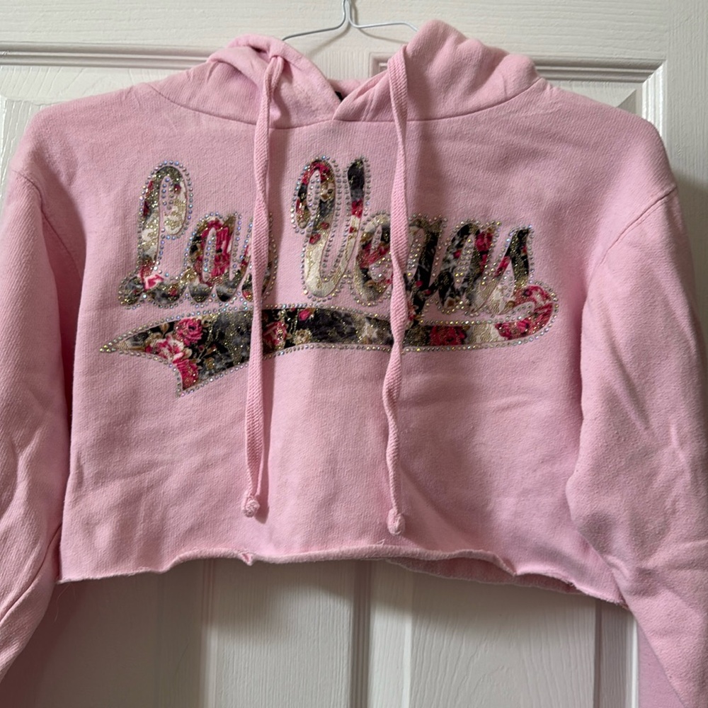 Cropped pink Las Vegas hoodie with rhinestones. Size small. Very good condition.